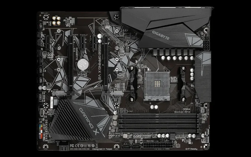 Gigabyte B550 X Gaming moderkort med AM4-sockel, DDR4-minnesplatser och svart design med geometriska mönster, fotograferat från ovan.